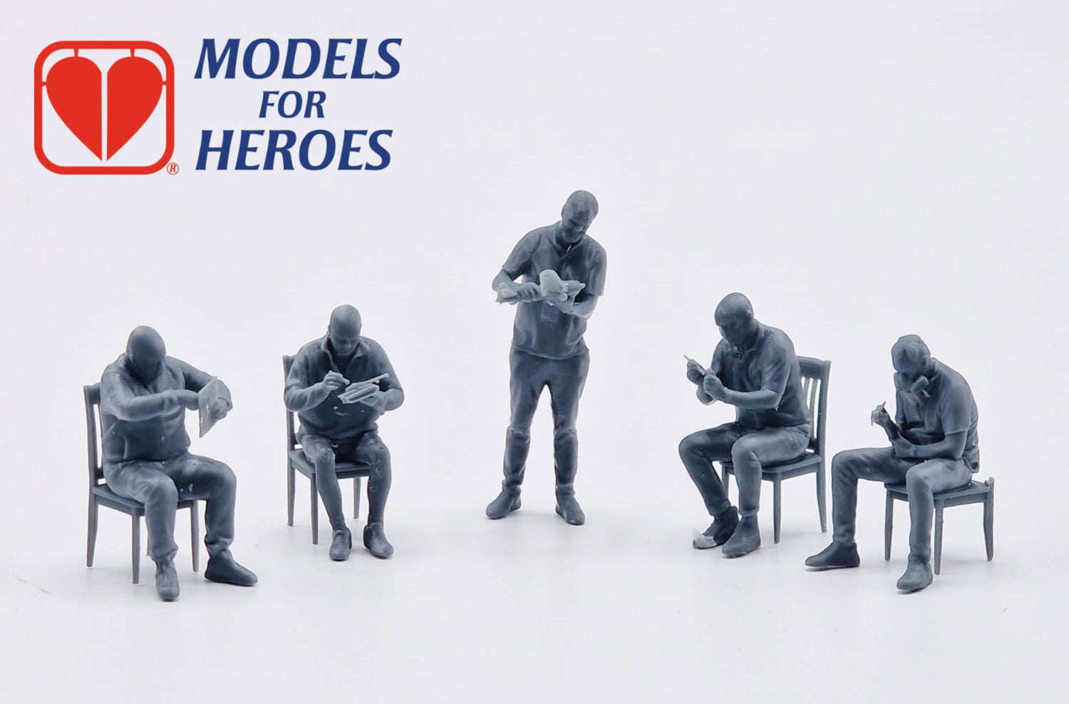Five miniature modeller figures from the Modelu x Models for Heroes collection, depicting hobbyists building and painting scale models