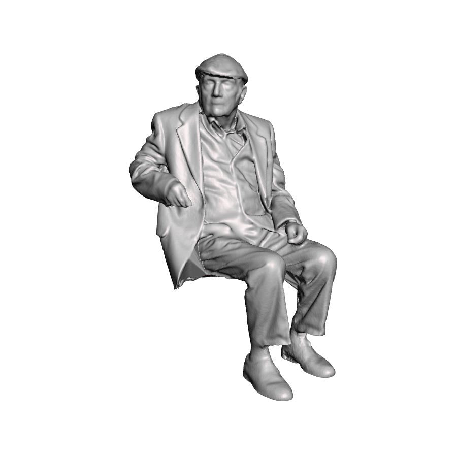 A seated man wearing flatcap