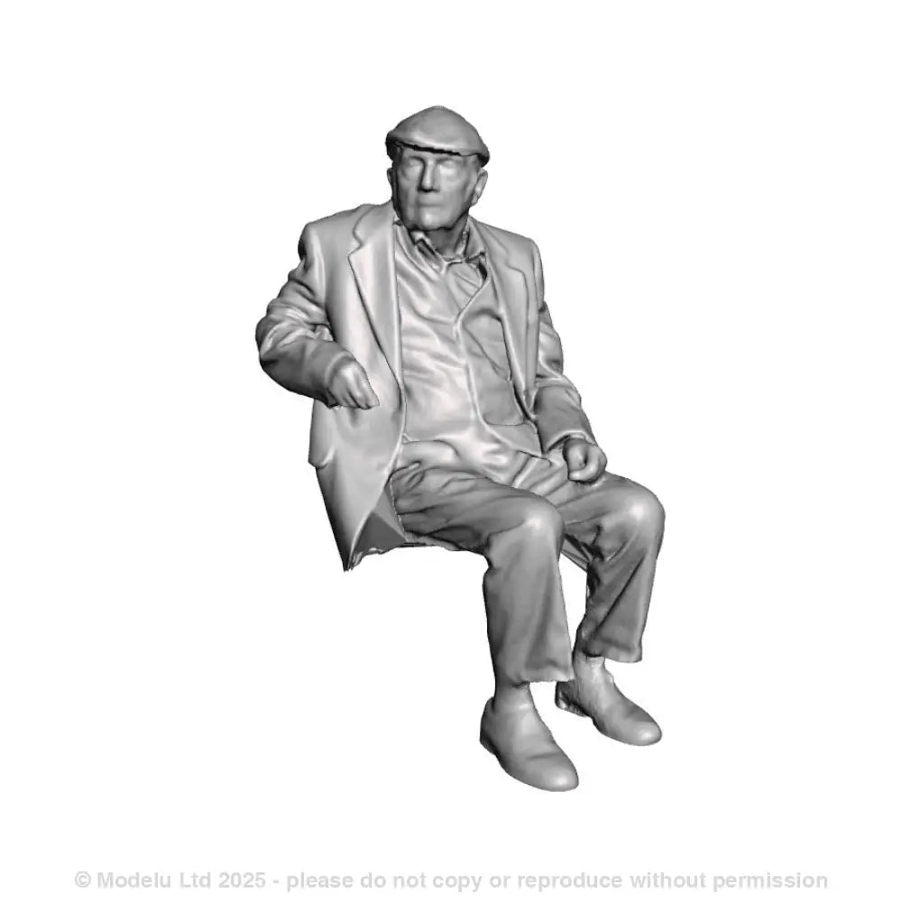A seated man wearing flatcap
