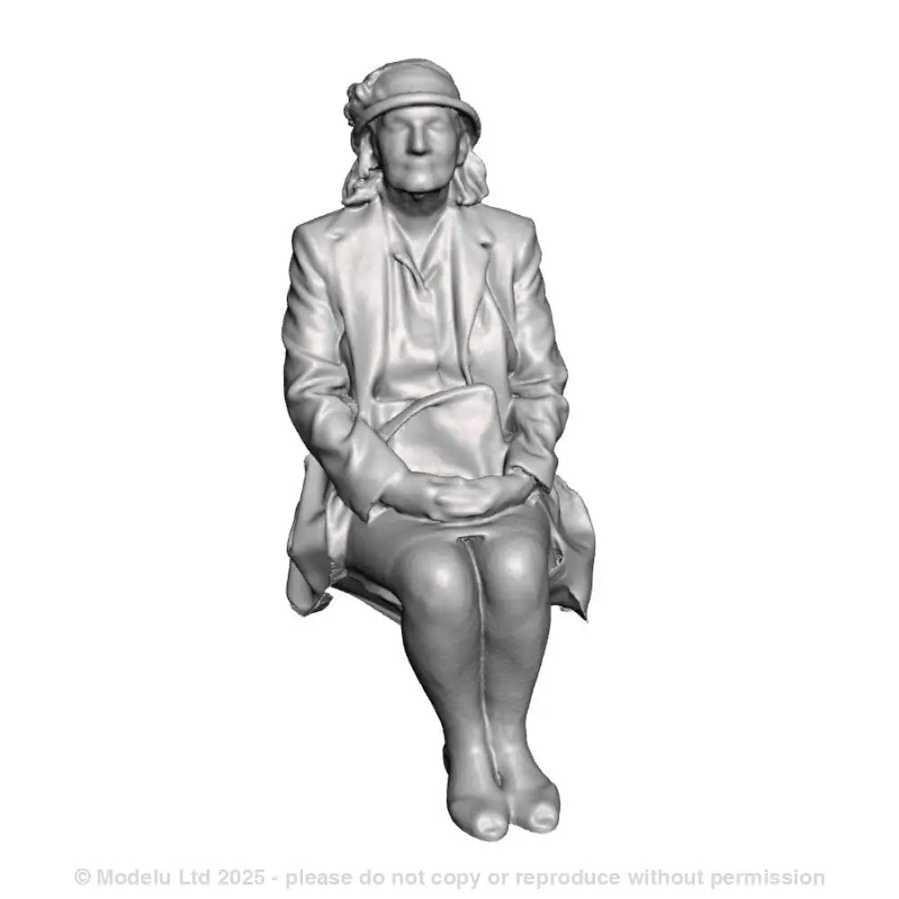 A seated woman with bag on lap