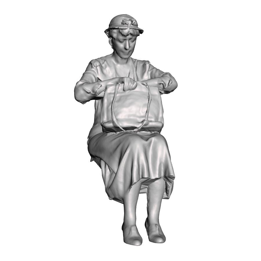 A seated woman looking in bag