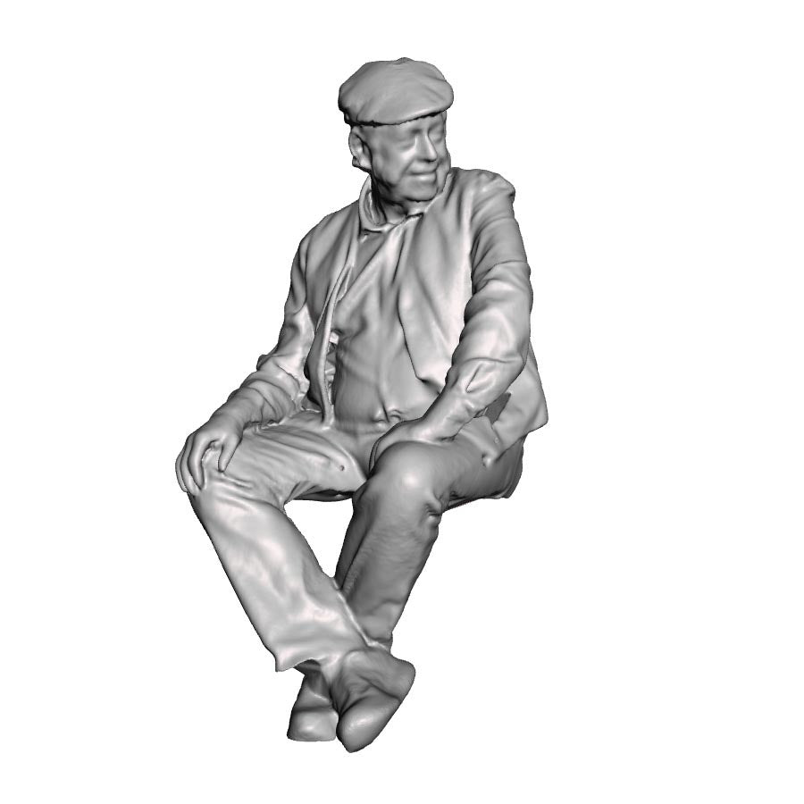 A seated man wearing flatcap