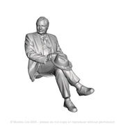 A seated man with crossed legs