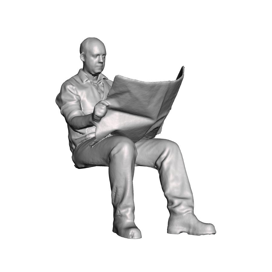 A seated man reading newspaper