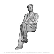 A seated man with crossed legs