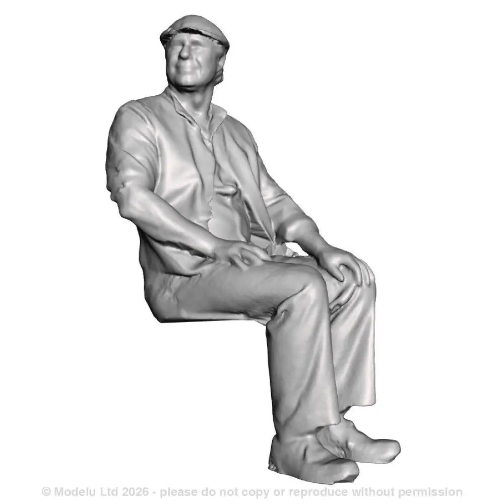 A seated man wearing flatcap
