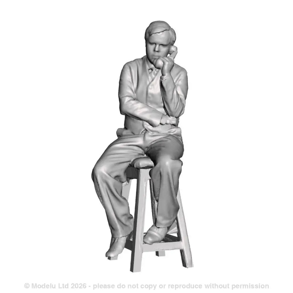 A signalman seated on a stool using a telephone