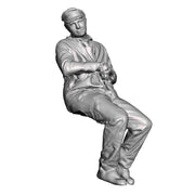 A loco crew man seated leaning