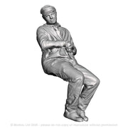 A loco crew man seated leaning