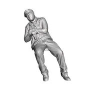 A loco crew man seated leaning