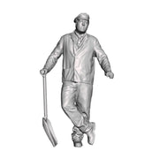 A fireman leaning holding a firing shovel