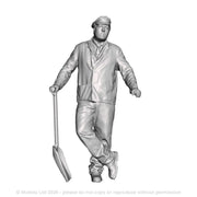 A fireman leaning holding a firing shovel