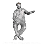 A loco driver seated operating a regulator