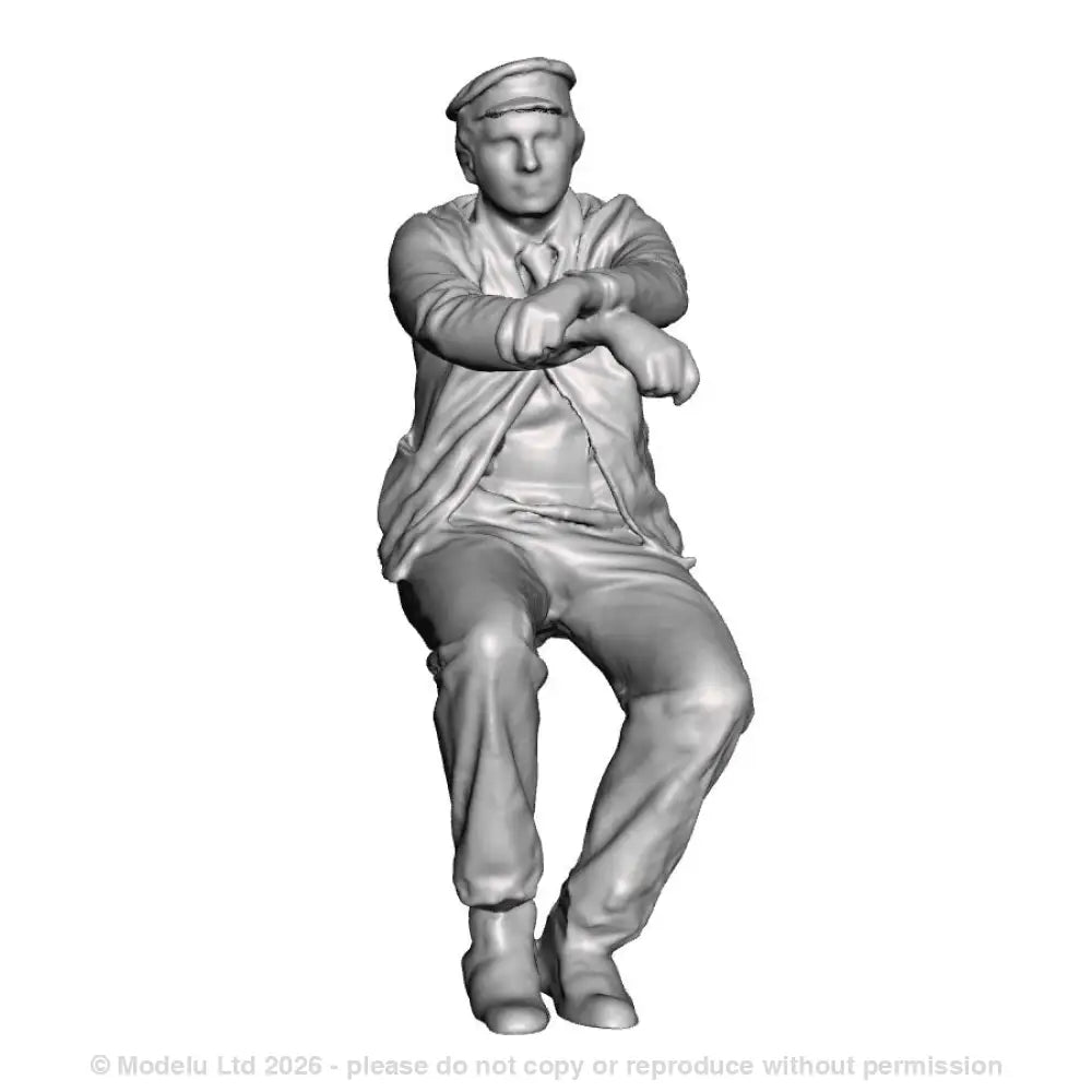 A loco driver seated operating a reverser