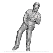 A loco crew man seated leaning