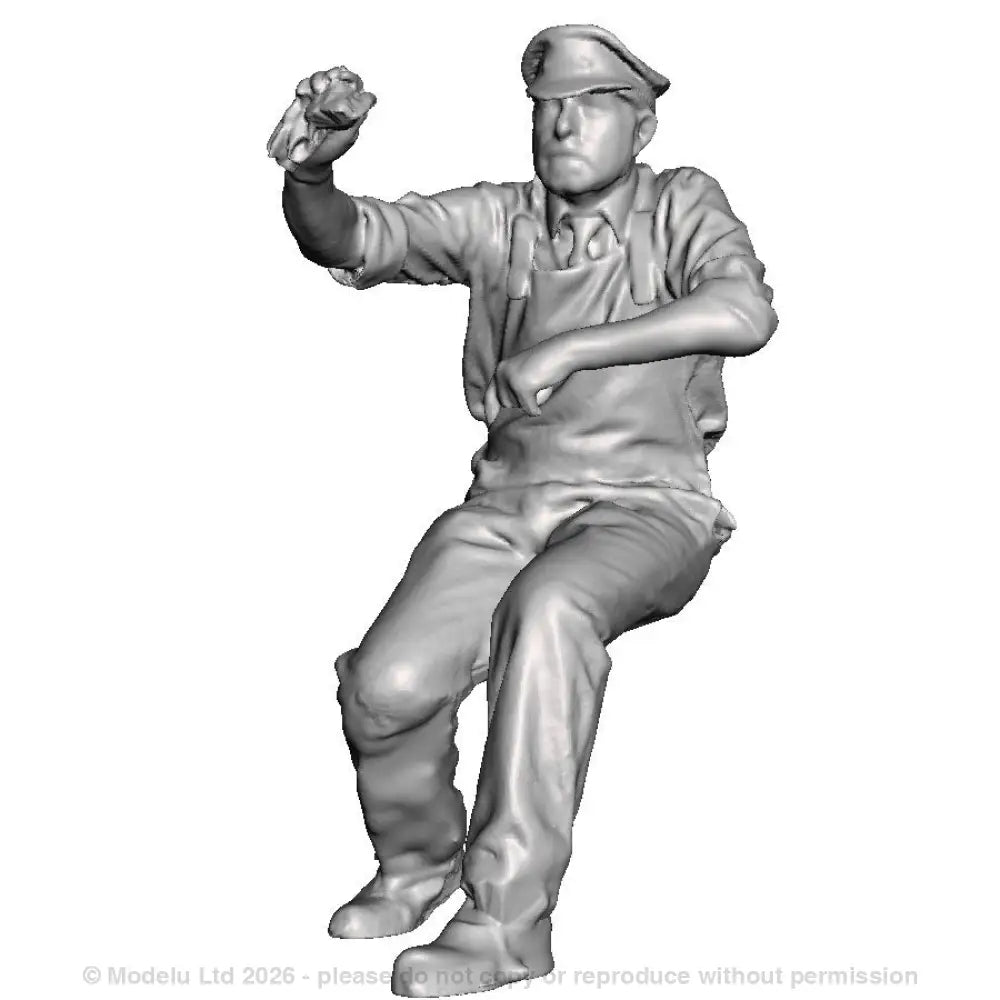 A loco crew man seated operating a regulator