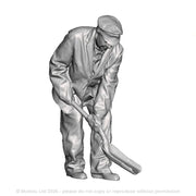 A fireman using a firing shovel in a small cab