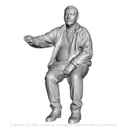 A loco driver seated operating a regulator