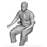 A loco driver seated operating a regulator