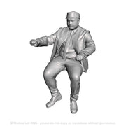 A loco driver seated operating a regulator