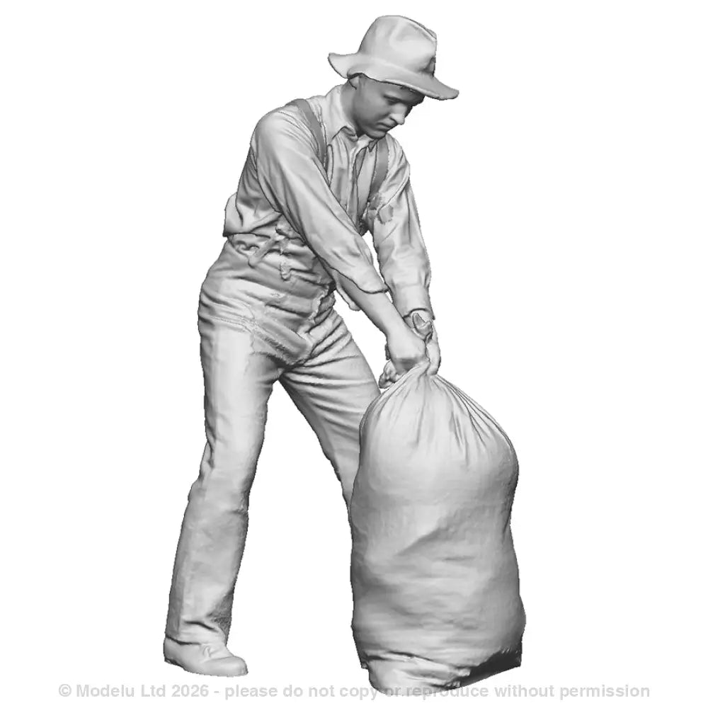 A mill worker moving sack
