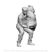 A mill worker lifting sack