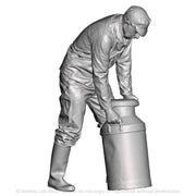 A creamery or dairy worker rolling a milk churn