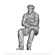 A male figure in flat cap seated