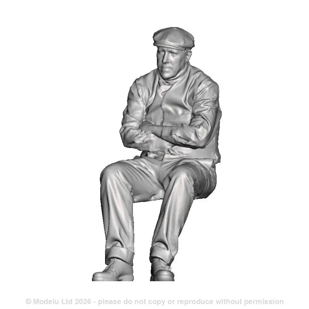 A male figure in flat cap seated