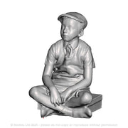 A school boy sitting on a suitcase