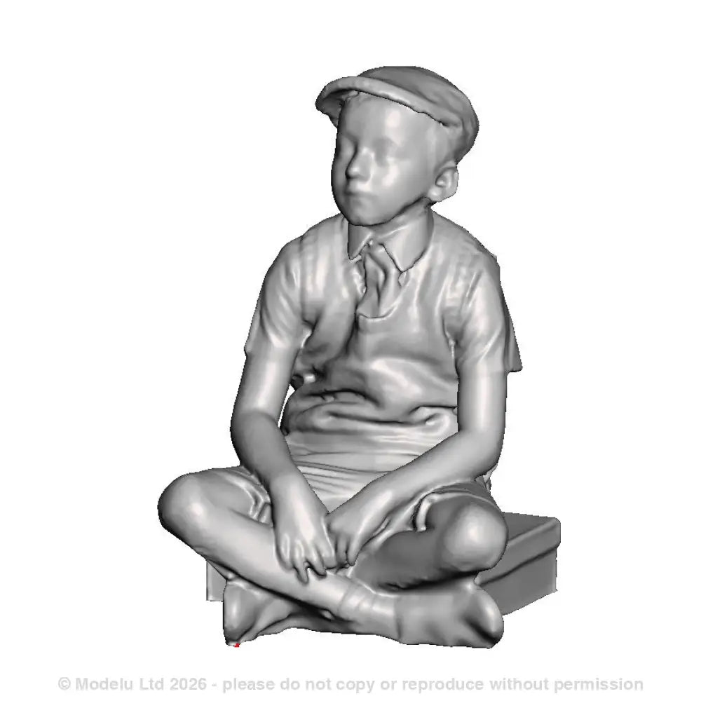 A school boy sitting on a suitcase