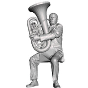 A male tuba player seated