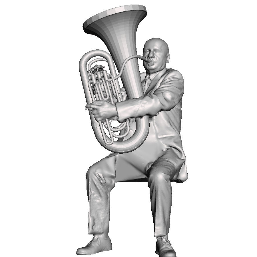 A male tuba player seated