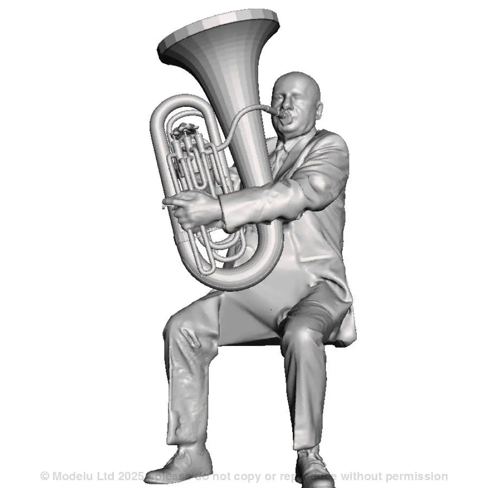 A male tuba player seated