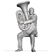 A male tuba player seated