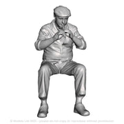 A male whistle player seated