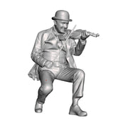 A male fiddle player seated