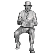 A male concertina player seated