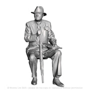 A male figure seated with umbrella