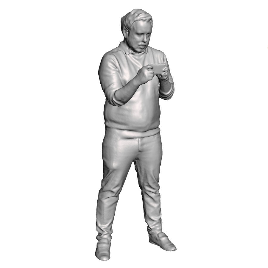 A male figure using a mobile phone