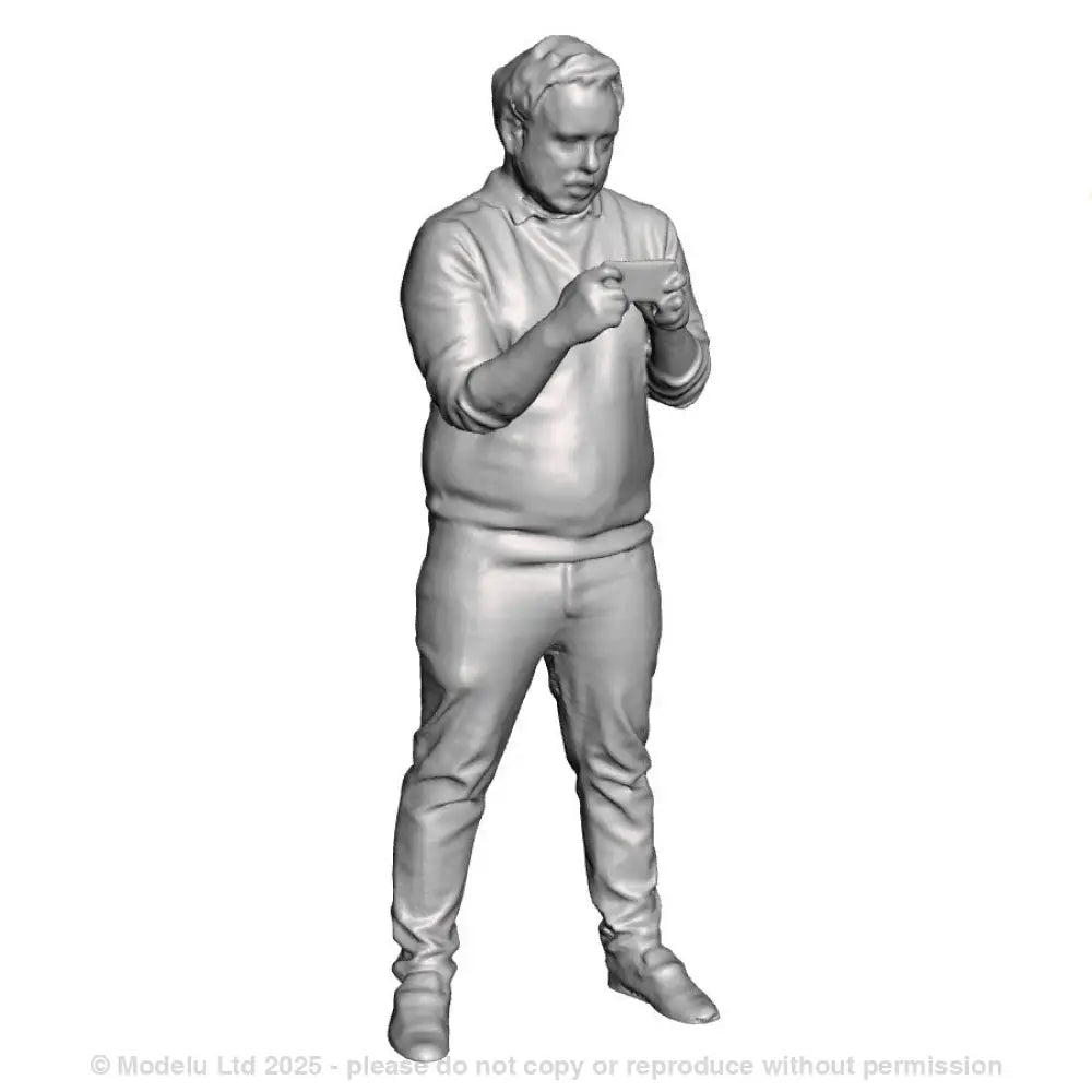 A male figure using a mobile phone