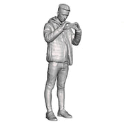 A male figure using a mobile phone