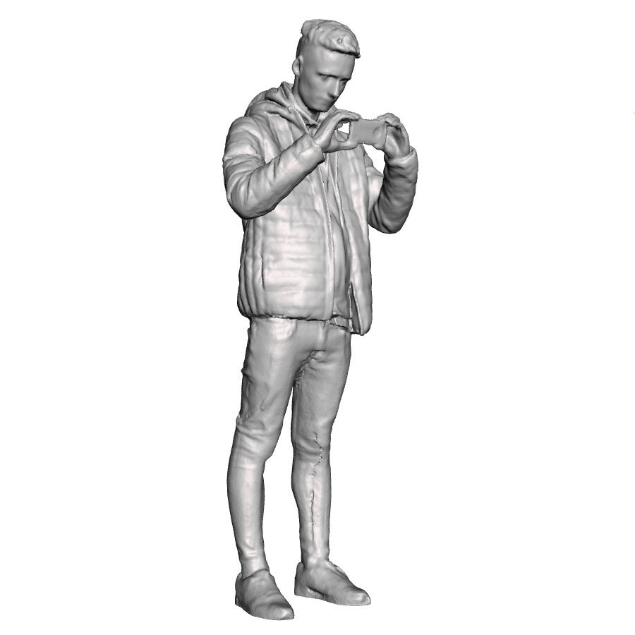 A male figure using a mobile phone