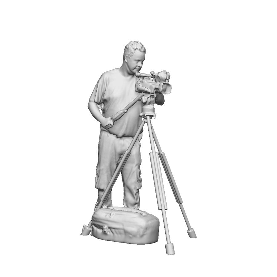 A male camera man with camera and tripod