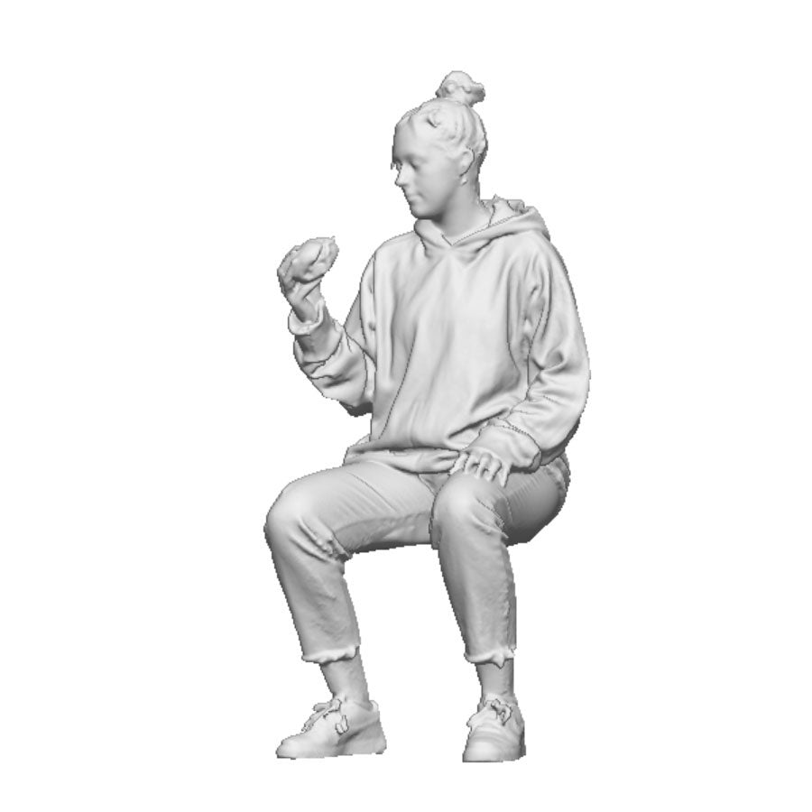 A female seated figure eating