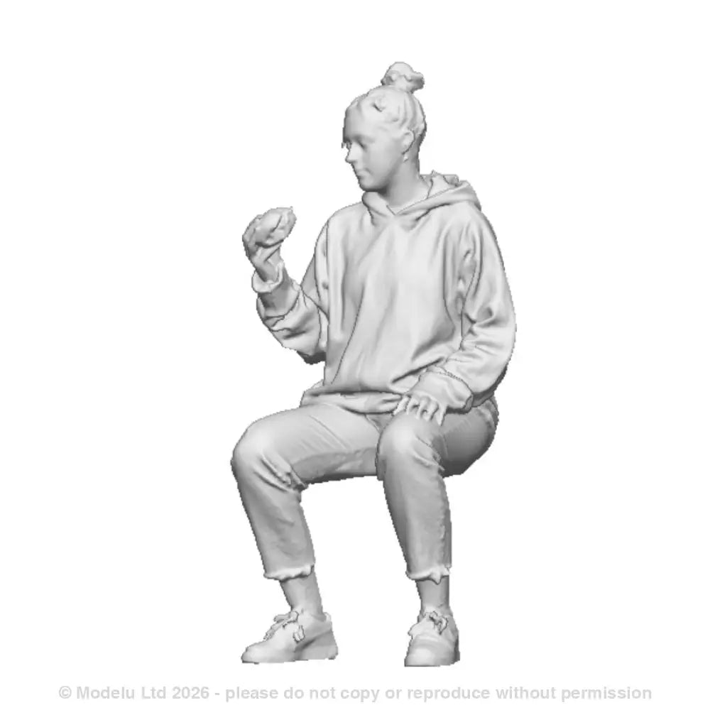 A female seated figure eating