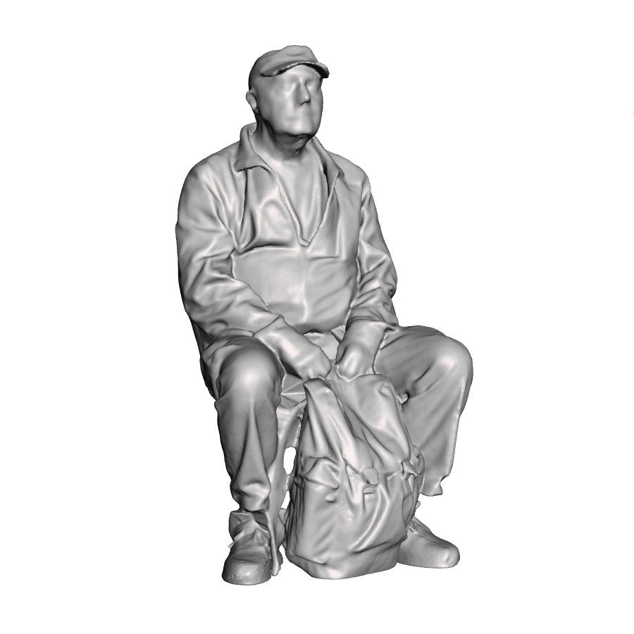 A male figure seated with rucksack