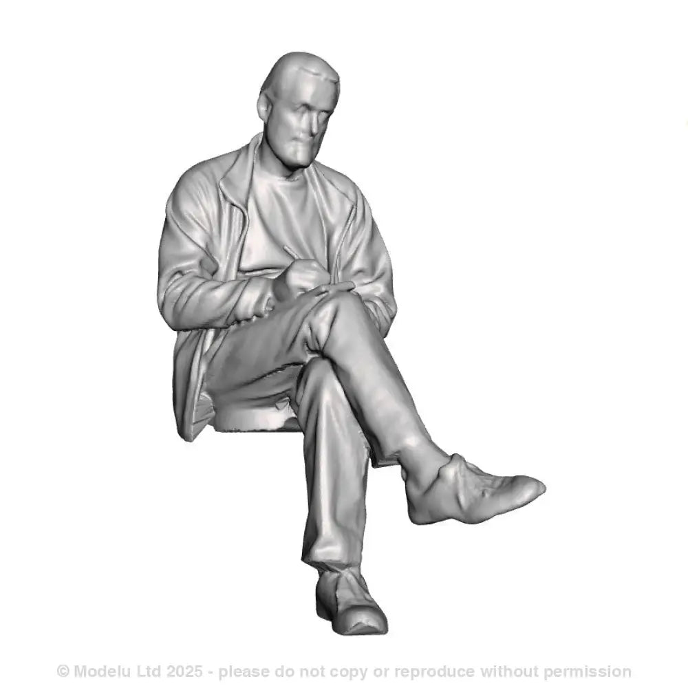 A male figure seated with notebook