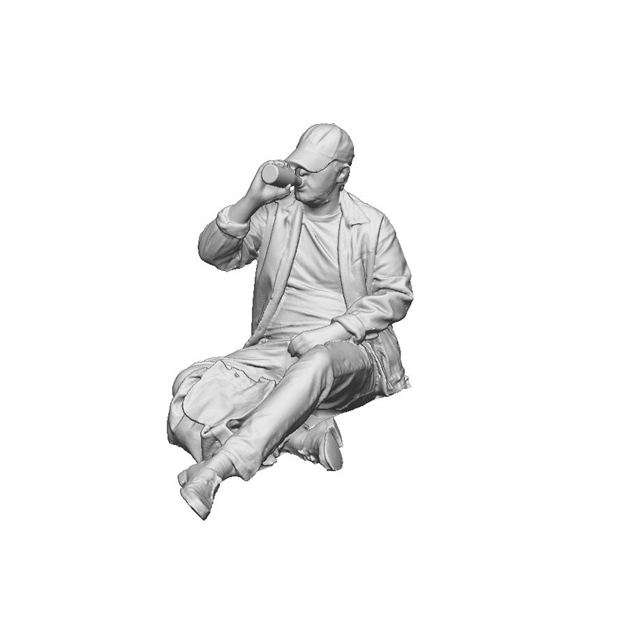 A seated man drinking